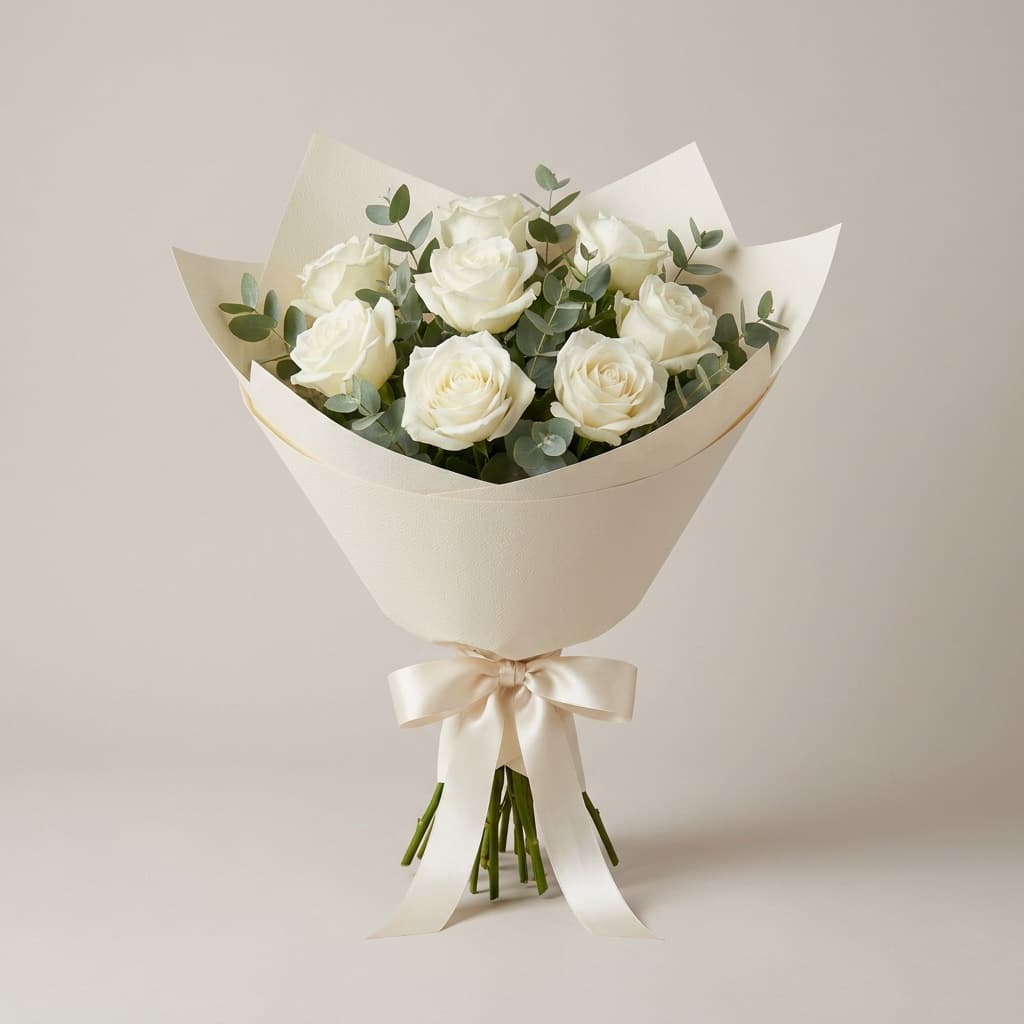 White roses wrapped and ribboned, ready for dispatch